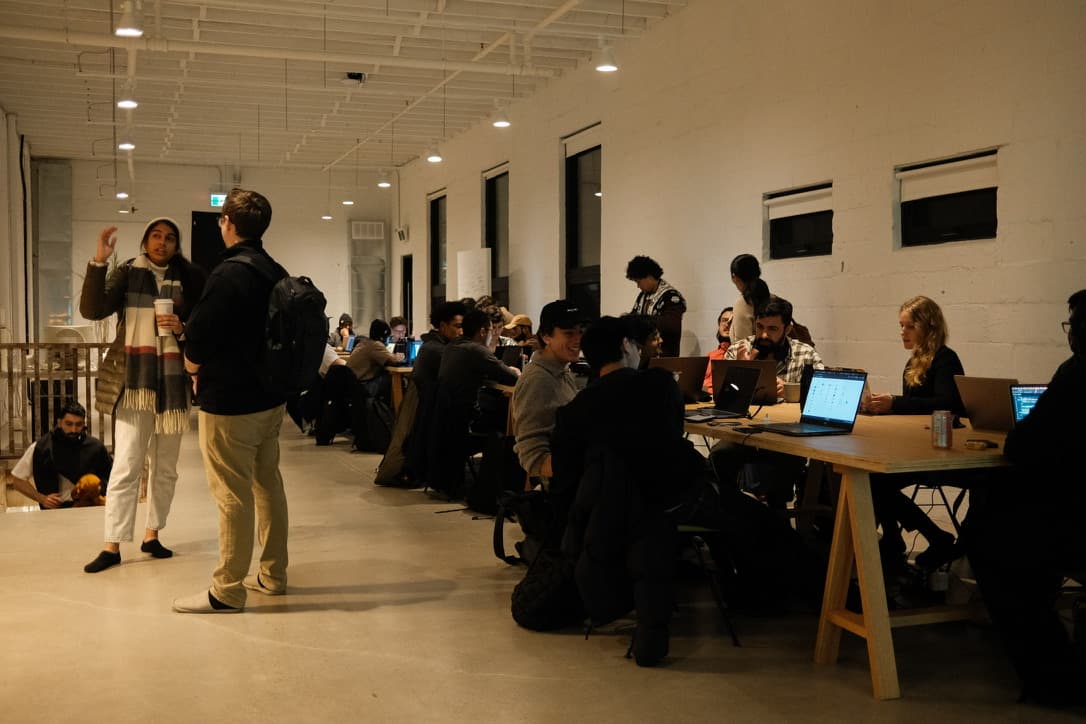 A long co-working table full of makers